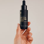 Vanessa Megan Anti-Frizz Smoothing Serum bottle in hand