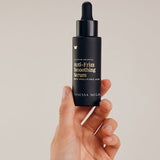 Vanessa Megan Anti-Frizz Smoothing Serum bottle in hand