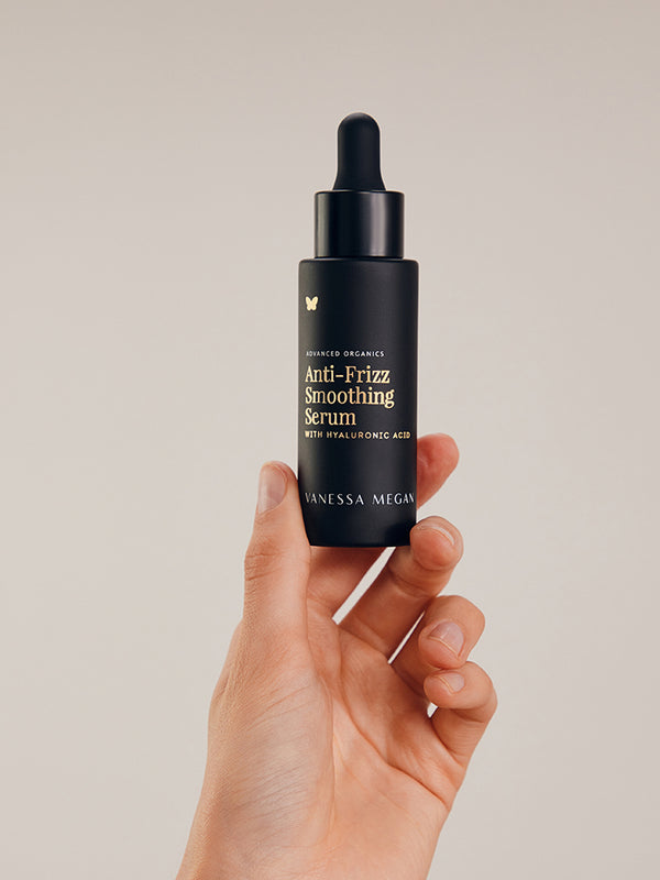 Vanessa Megan Anti-Frizz Smoothing Serum bottle in hand