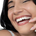 Smiling woman wearing Hurraw! Hazelnut Tinted Lip Balm – Hurraw! Organic Lip Balm - Hazelnut 4.8g