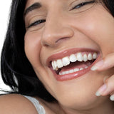 Smiling woman wearing Hurraw! Hazelnut Tinted Lip Balm – Hurraw! Organic Lip Balm - Hazelnut 4.8g