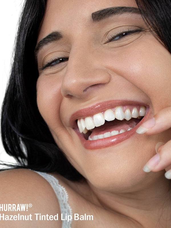 Smiling woman wearing Hurraw! Hazelnut Tinted Lip Balm – Hurraw! Organic Lip Balm - Hazelnut 4.8g