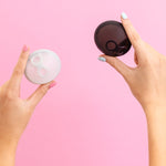 Hello Period Sea Fog and Black menstrual discs held in hand
