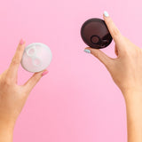 Hello Period Sea Fog and Black menstrual discs held in hand