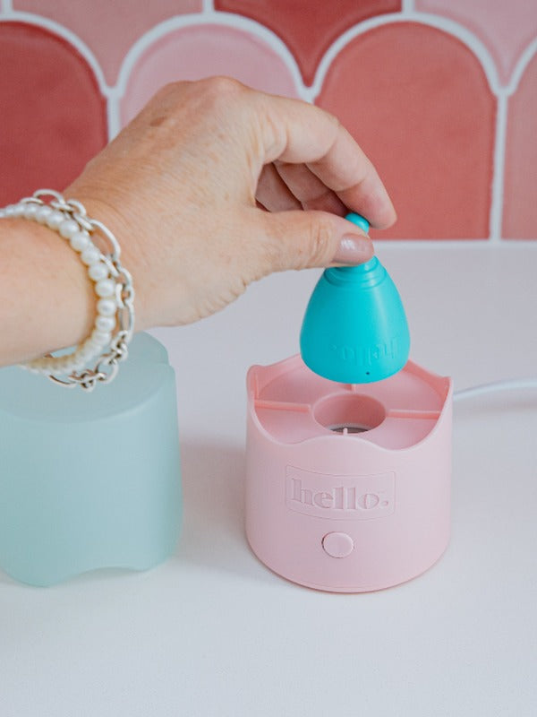 Hello Period menstrual cup being placed in the Steamy steriliser