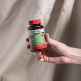 Hand holding the Herbs of Gold Children's Magnesium Care bottle