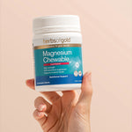 Hand holding the Herbs of Gold Magnesium Chewable tub