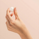 Hand holding a Herbs of Gold Magnesium Chewable raspberry tablet