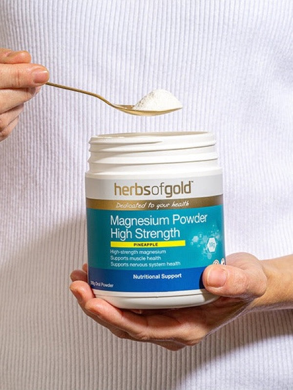 Spoon of Herbs of Gold Magnesium Powder High Strength being scooped from the tub