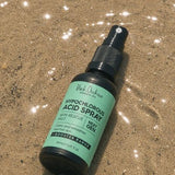 Black Chicken Hypochlorous Acid Spray – Skin Rescue Mist bottle on sand – Black Chicken Remedies Hypochlorous Acid Spray Skin Rescue Mist 50ml