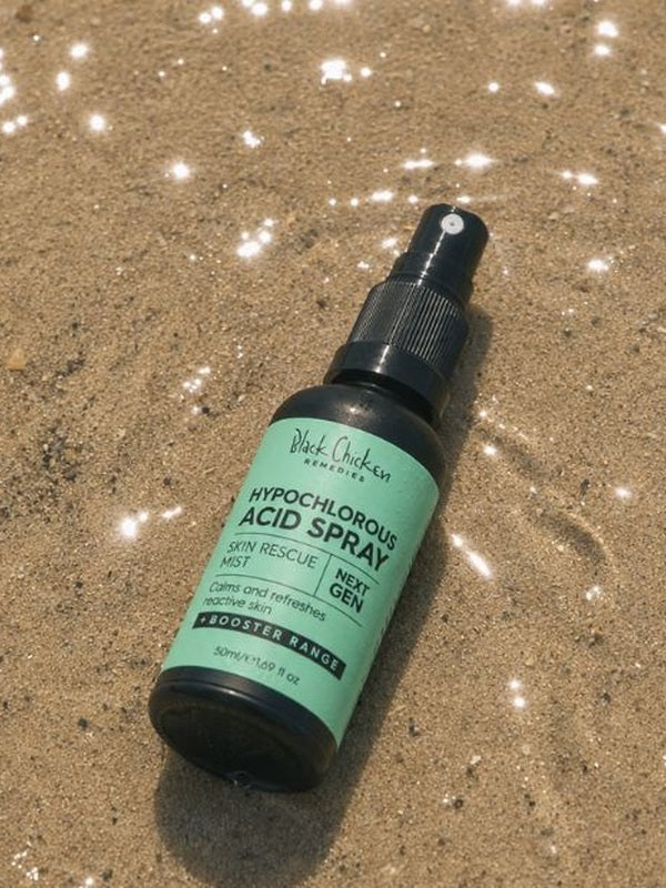 Black Chicken Hypochlorous Acid Spray – Skin Rescue Mist bottle on sand – Black Chicken Remedies Hypochlorous Acid Spray Skin Rescue Mist 50ml