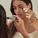 Woman applying eye serum in front of a mirror – Black Chicken Remedies ICU Intensive Care Eye Serum 9ml