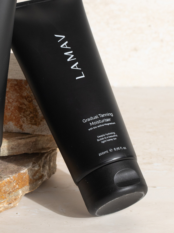 LAMAV Gradual Tanning Moisturiser tube on a neutral background