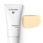 A white tube labeled Dr Hauschka Foundation 30ml is displayed beside a beige swatch of this natural, medium-coverage foundation, set against a white background.