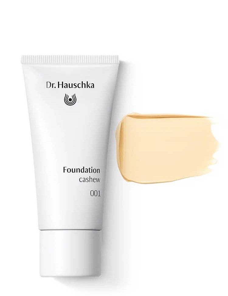 A white tube labeled Dr Hauschka Foundation 30ml is displayed beside a beige swatch of this natural, medium-coverage foundation, set against a white background.