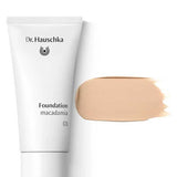 A 30ml tube of Dr Hauschka Foundation is displayed in the shade macadamia 01, alongside a swatch of its light beige, natural medium coverage formula on a white background.