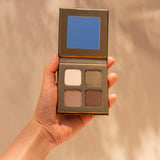 Woman’s hand holding INIKA Organic Eyeshadow Quad in Wind