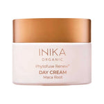 Round pale pink INIKA Phytofuse Renew Day Cream jar with a broad gold lid and gold lettering naming Maca Root, against a white background.