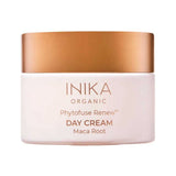 Round pale pink INIKA Phytofuse Renew Day Cream jar with a broad gold lid and gold lettering naming Maca Root, against a white background.