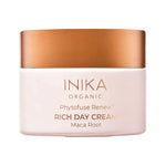 Round pale pink INIKA Phytofuse Renew Rich Day Cream jar with a broad gold lid and gold lettering naming Maca Root, against a white background.