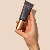 Hand holding INIKA Organic Pure Perfection Primer