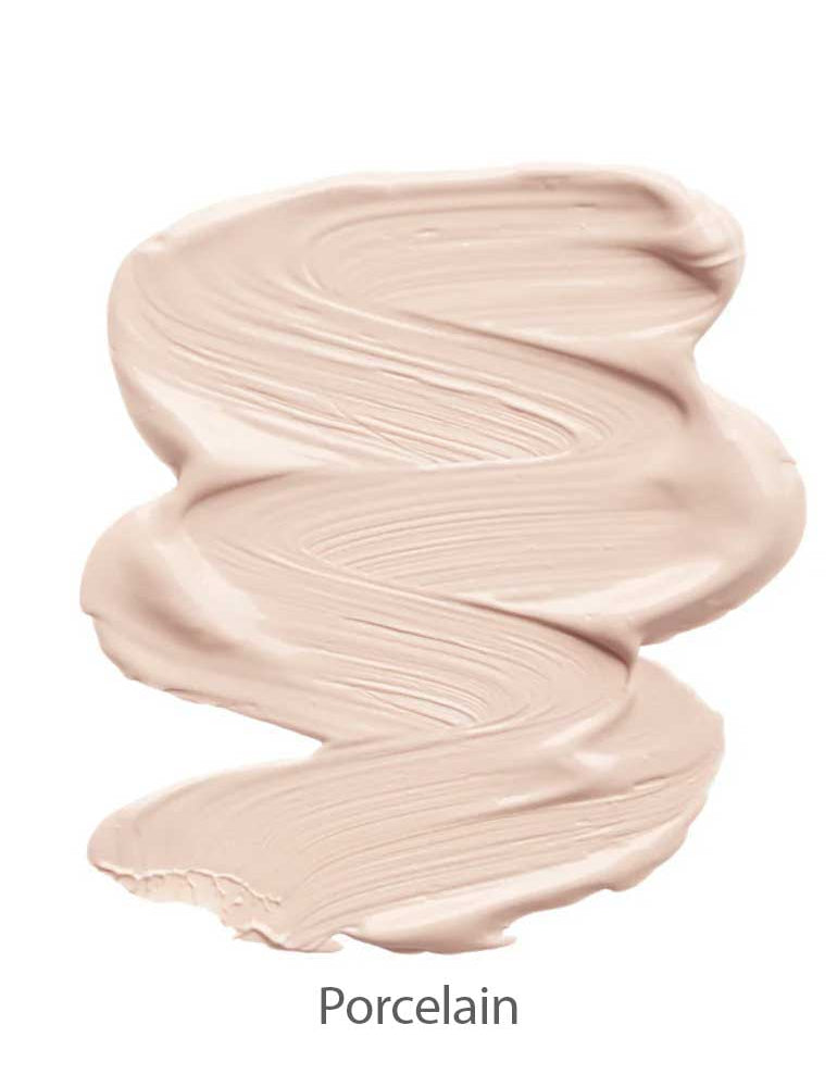 A smooth, creamy swirl of light beige INIKA Organic Sheer Coverage Concealer 10ml with a silky texture is shown on a white background. The word "Porcelain" appears below the swatch, indicating the shade.