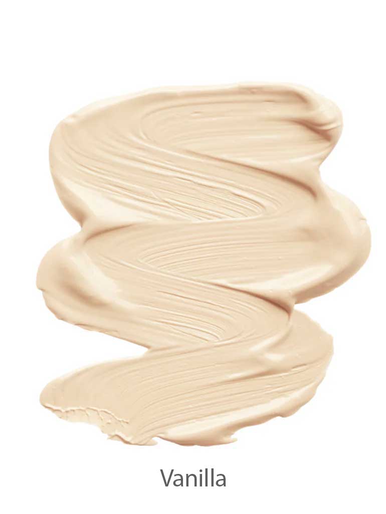 A smooth, creamy swatch of INIKA Organic Sheer Coverage Concealer 10ml in light beige with visible brush strokes, labeled Vanilla at the bottom.