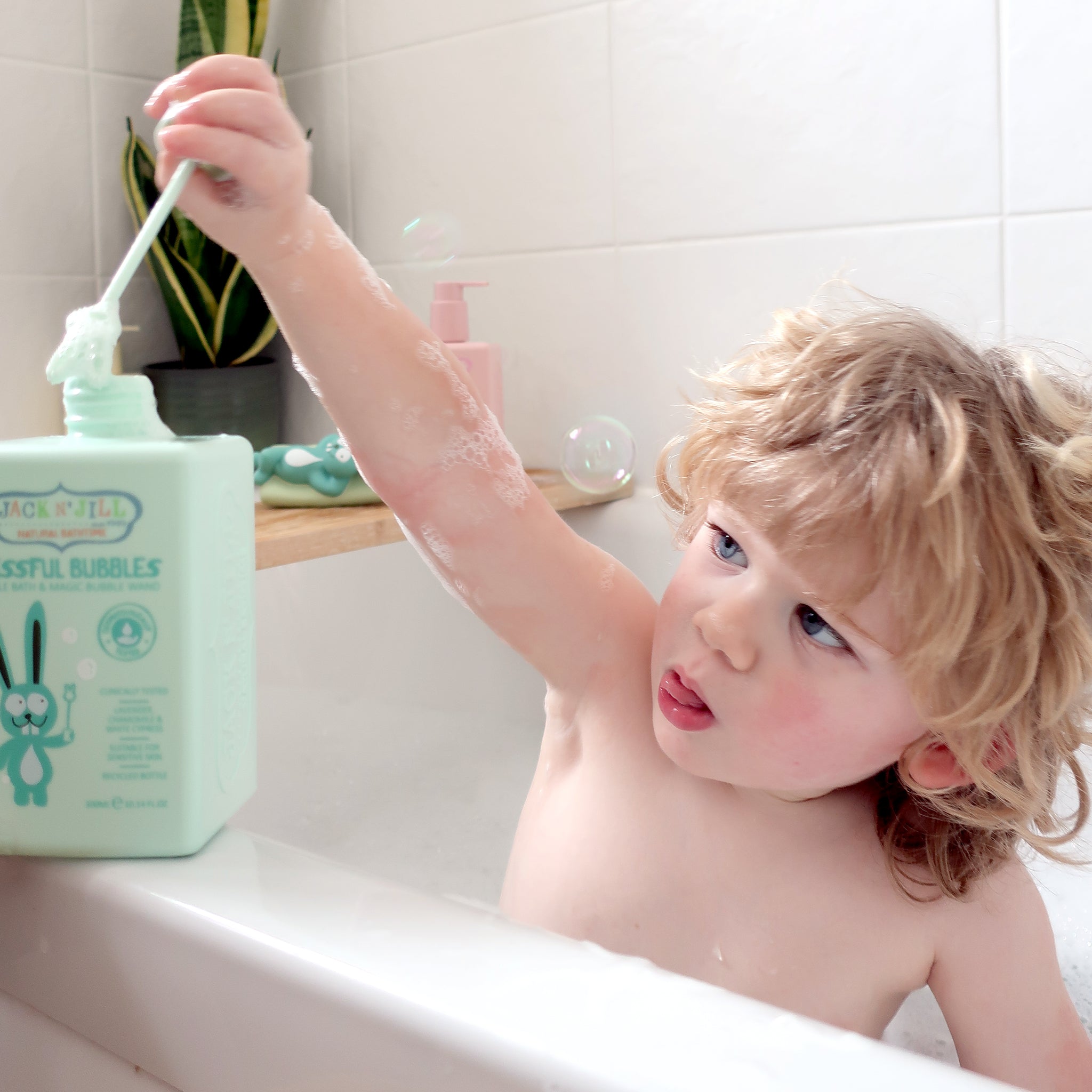 Child playing with Jack N' Jill Blissful Bubbles in the bath