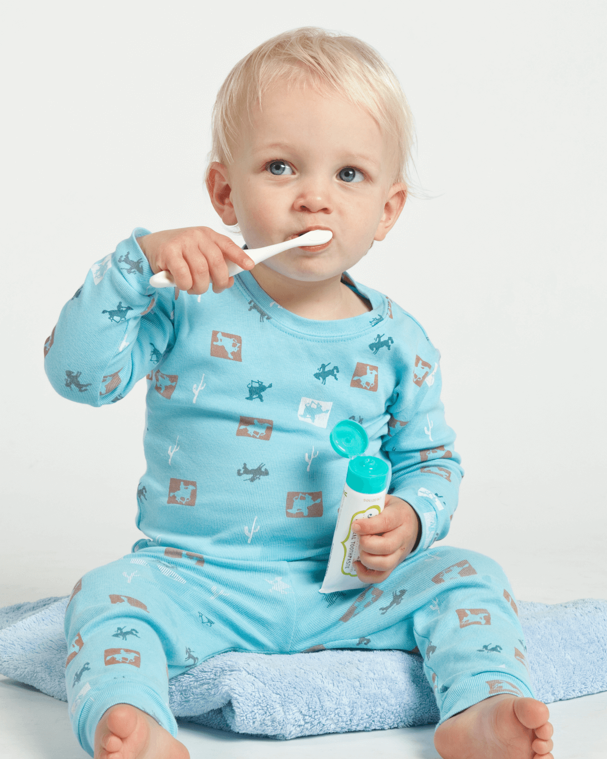 Young child using Jack N' Jill blueberry toothpaste