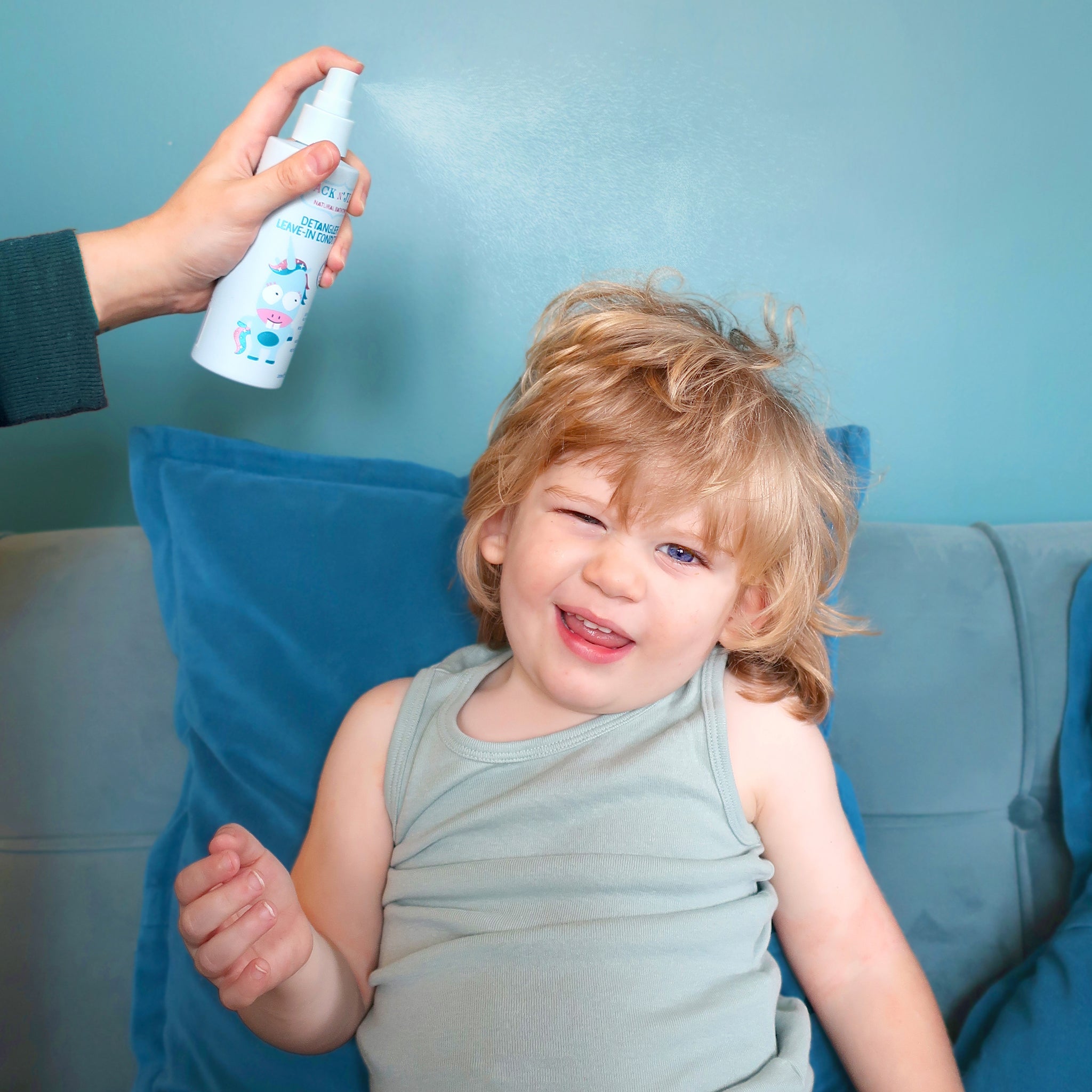 Jack N' Jill detangler being sprayed onto a child's hair