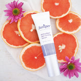 Juniper Antioxidant Skin Firming Serum styled with grapefruit and flowers