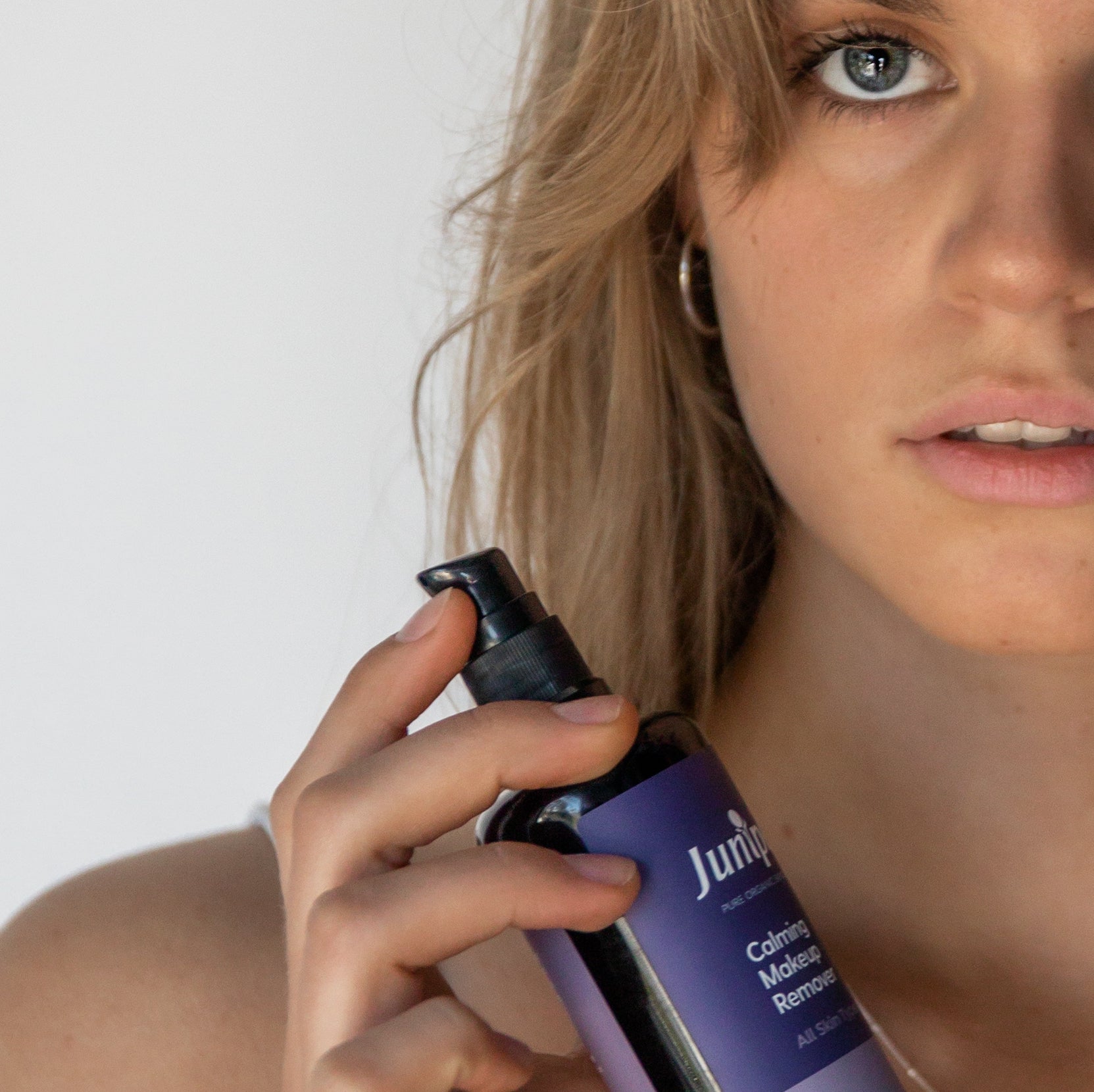 Woman holding Juniper Calming Makeup Remover
