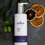 Juniper Intensive Body Lotion styled with citrus and olive branches