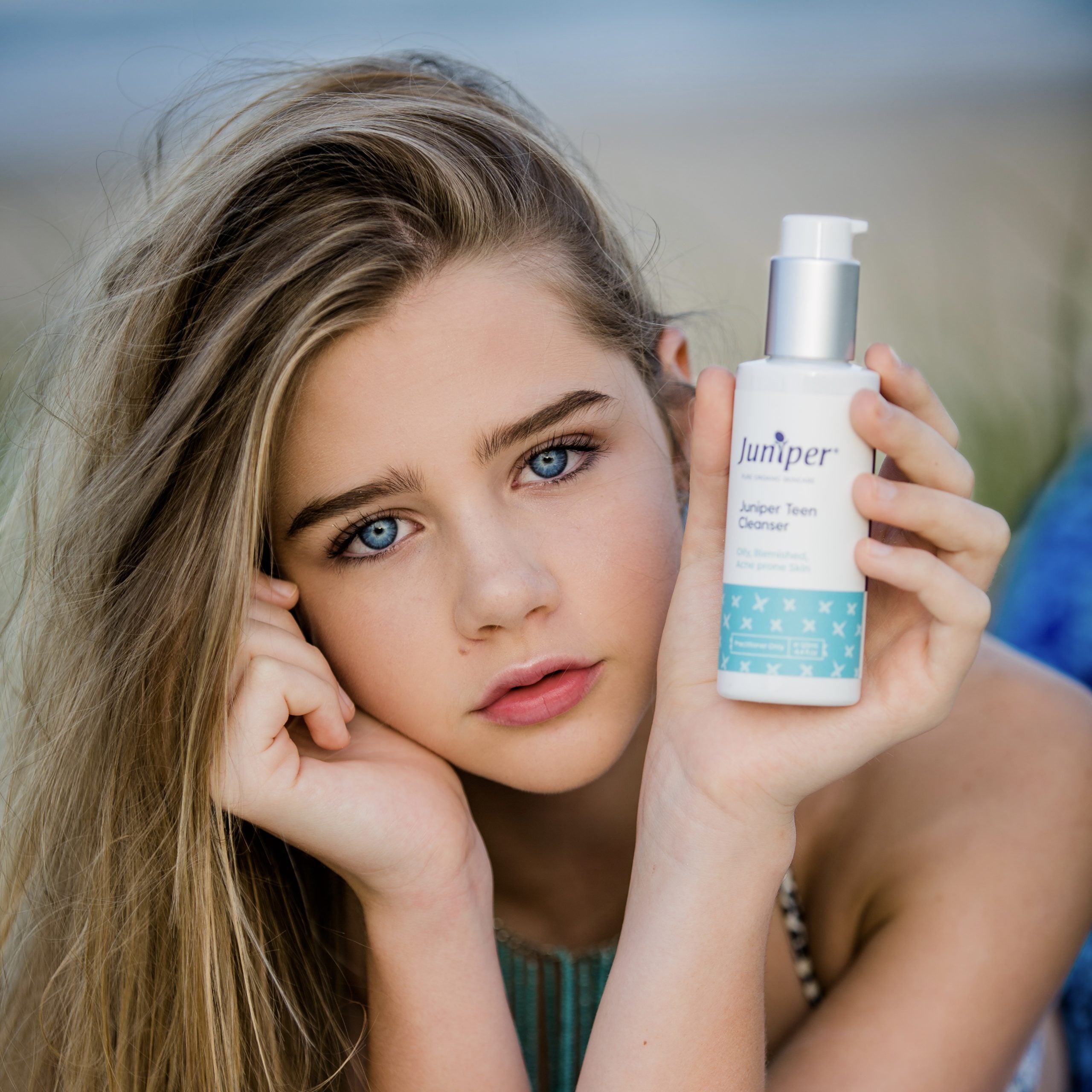 Young woman holding Juniper Teen Cleanser