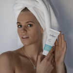 Young woman holding Juniper Teen Exfoliant