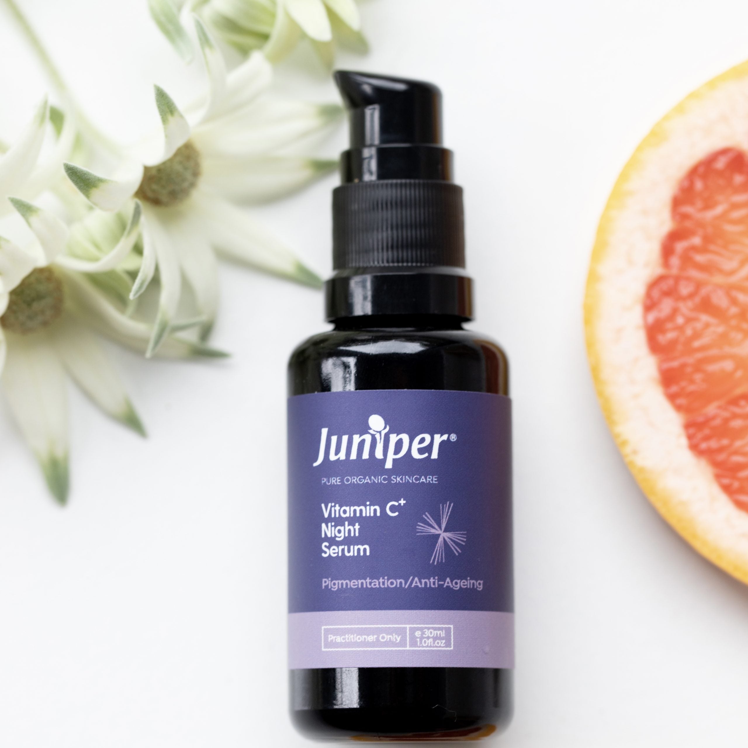 Juniper Vitamin C Night Serum styled with grapefruit and flowers