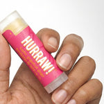Hand holding Hurraw! Kapha Lip Balm Grapefruit Ginger & Eucalyptus 4.8g