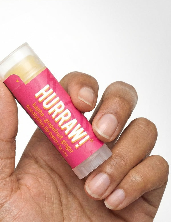 Hand holding Hurraw! Kapha Lip Balm Grapefruit Ginger & Eucalyptus 4.8g
