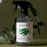 Koala Eco Bathroom Cleaner styled among eucalyptus branches on a deep green background