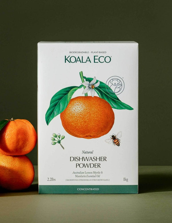 Koala Eco Lemon Myrtle and Mandarin Dishwasher Powder styled with fresh mandarins