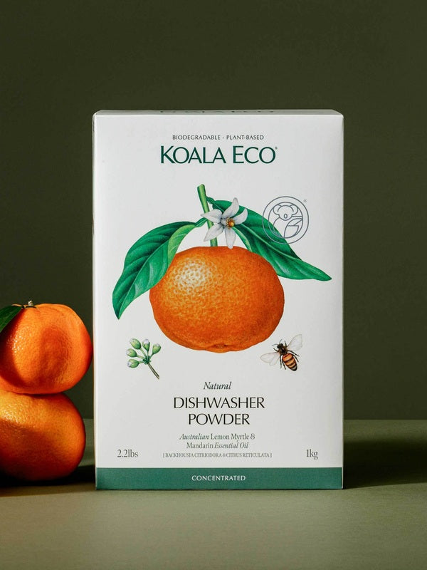 Koala Eco Lemon Myrtle and Mandarin Dishwasher Powder styled with fresh mandarins