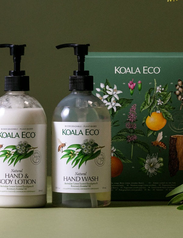 Koala Eco Eucalyptus and Rosemary Hand Care Gift Pack styled with greenery against a deep green background
