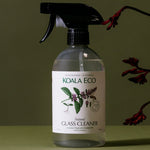 Koala Eco Peppermint Glass Cleaner styled with native flowers on a deep green background