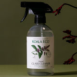 Koala Eco Peppermint Glass Cleaner styled with native flowers on a deep green background