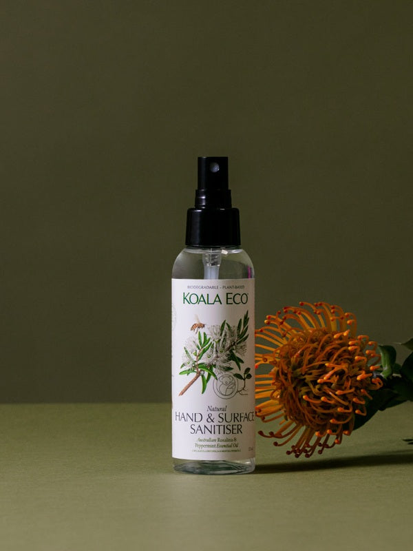 Koala Eco Rosalina and Peppermint Hand and Surface Spray styled with an orange banksia flower