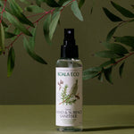 Koala Eco Lemon Scented Tea Tree Hand and Surface Spray styled beneath eucalyptus branches