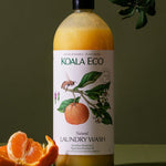 Koala Eco Mandarin and Peppermint Laundry Wash styled with fresh mandarin fruit