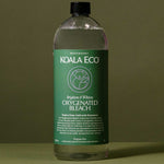 Koala Eco Oxygenated Bleach styled on a deep green background with soft botanical shadows
