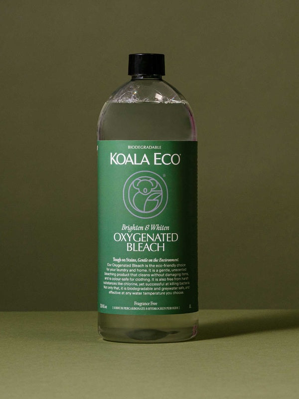 Koala Eco Oxygenated Bleach styled on a deep green background with soft botanical shadows
