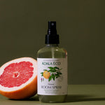 Koala Eco Pink Grapefruit and Peppermint Room Spray styled with fresh grapefruit